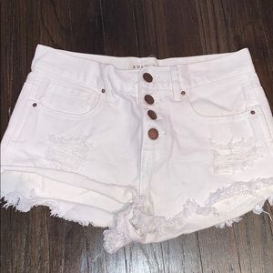 Low rise distressed white denim shorts
